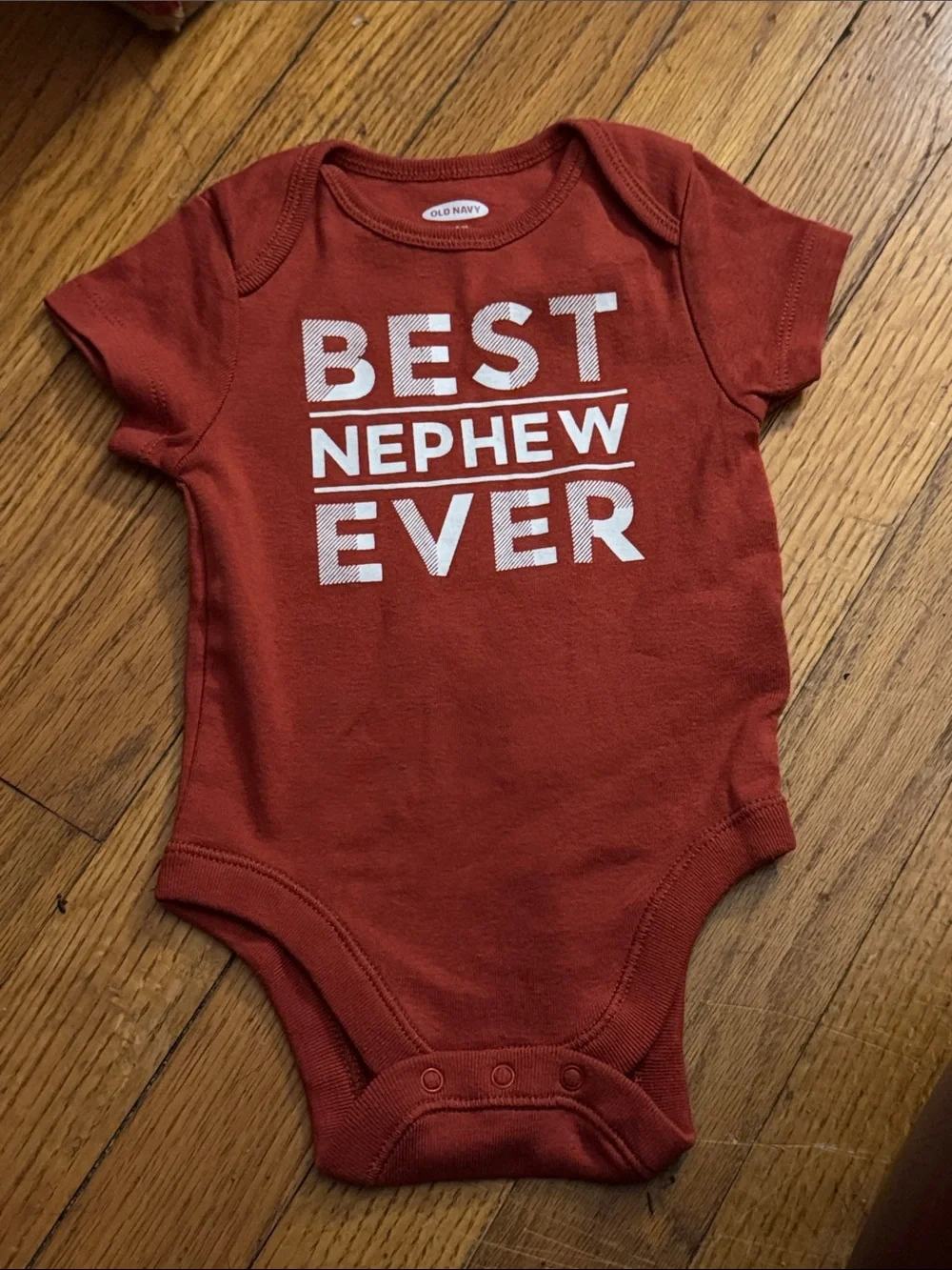 Infant short sleeve, Sepia/ Rust Onesie  with “Best Nephew Ever” Graphic.  NWOT